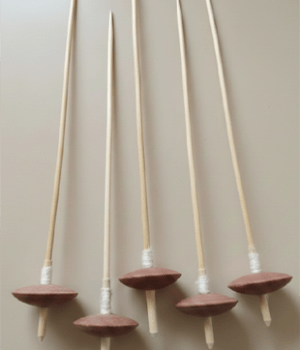 Wooden supported spindles with clay whorls, used for hand-spinning cotton fibers into yarn. Apan Mithila Todayuse Mithilause Mithila use