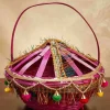 Handmade-woven bamboo basket (known as a Phuldali or Saji). Red colored basket is a staple of Mithila culture in Bihar, India, and is primarily used to carry flowers for religious rituals. The basket features a conical, ventilated lid adorned with gold tinsel, colorful embroidery, and hanging decorative tassels with small metallic bells, topped with a tall, curved handle for easy carrying. todayuse or apan mithila